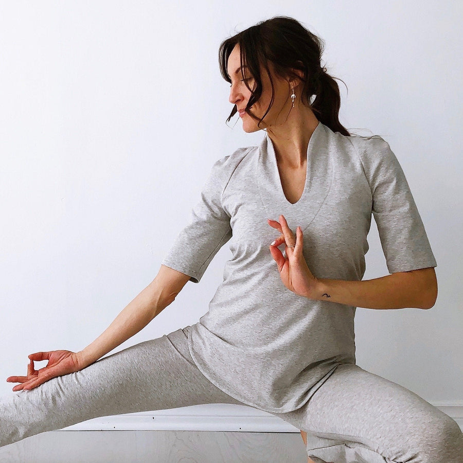 Grounded lunge in the light grey mid sleeve tunic